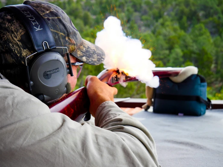 a man shooting an electronic rifle at the target