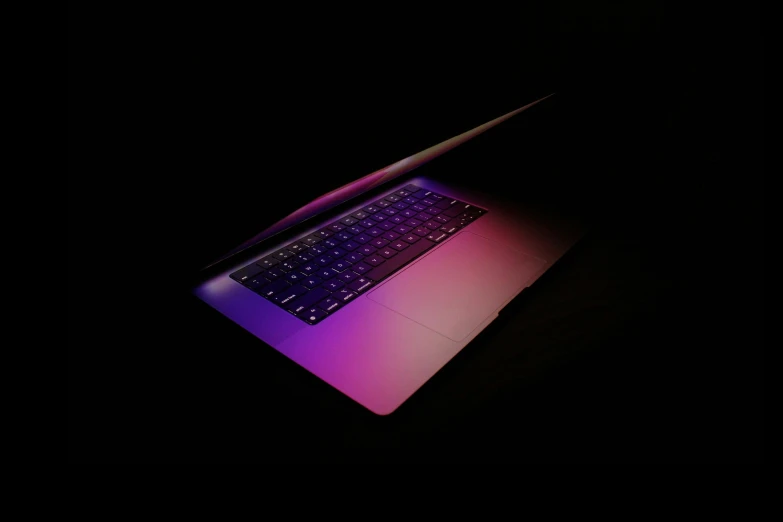 a laptop computer is glowing brightly pink and purple