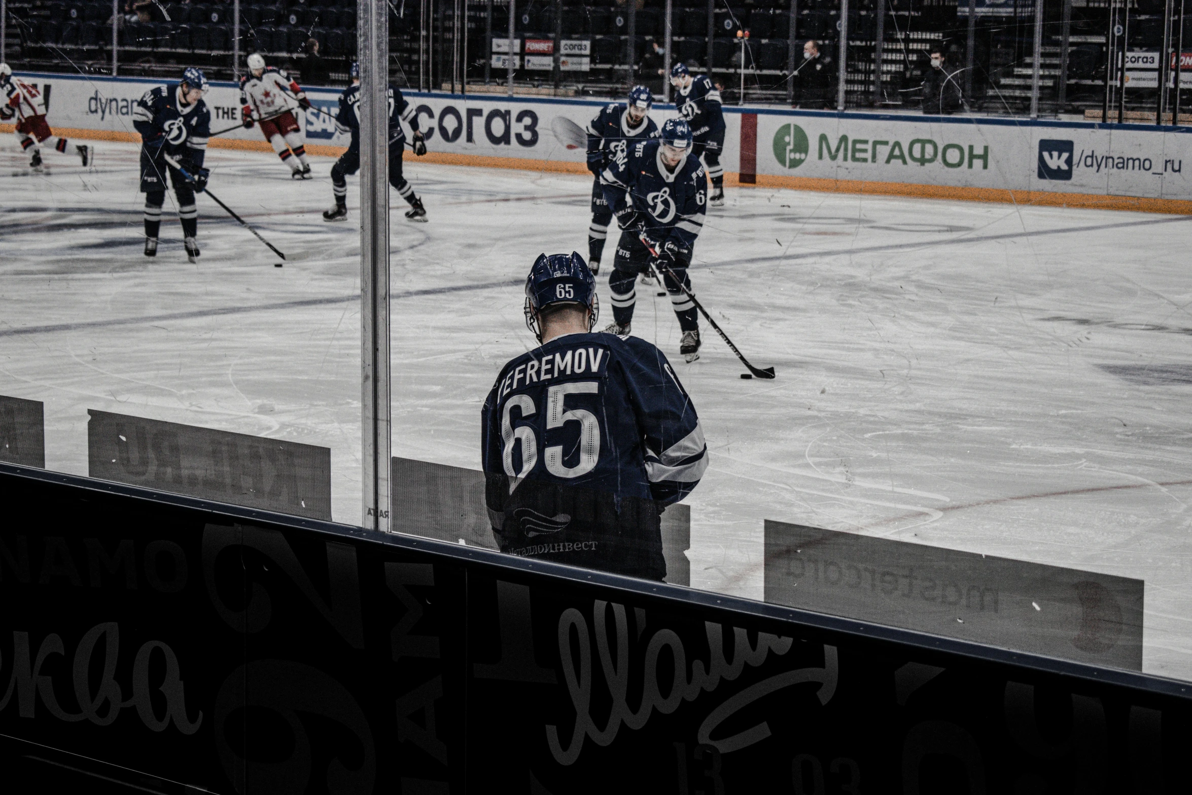 hockey players are seen playing in a game on ice