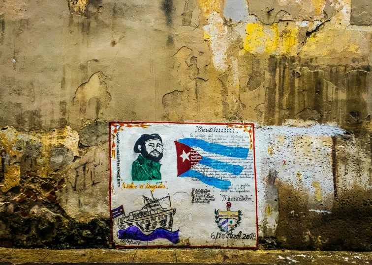 a faded graffiti on an old wall depicting a man with a flag