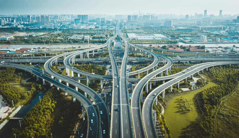 multiple traffic intersections with tall buildings in the background