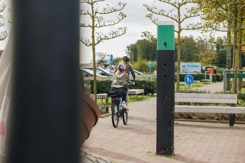 a man is riding a bike on the sidewalk