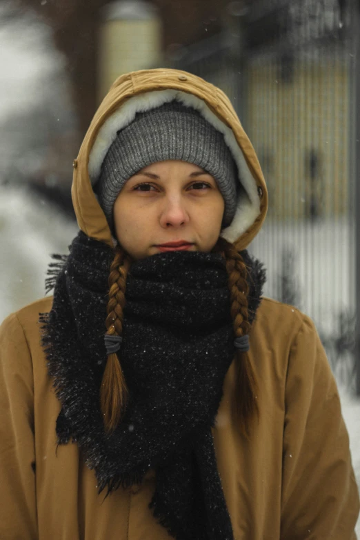 a woman with a id is standing in the snow