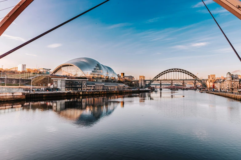 the water is calm and reflecting the view of the city