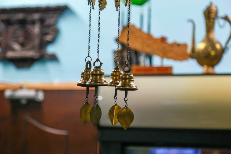 a trio of bells suspended from a chain