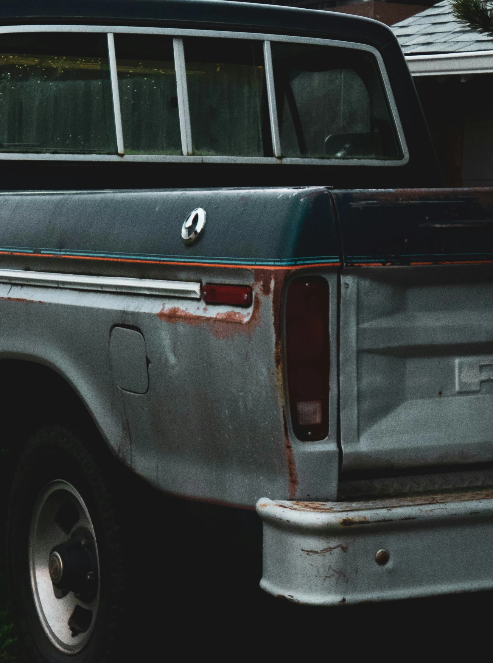 a gray truck with its doors open sits parked in the driveway