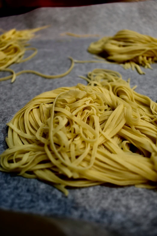 several uncooked noodles that have been washed up on a table