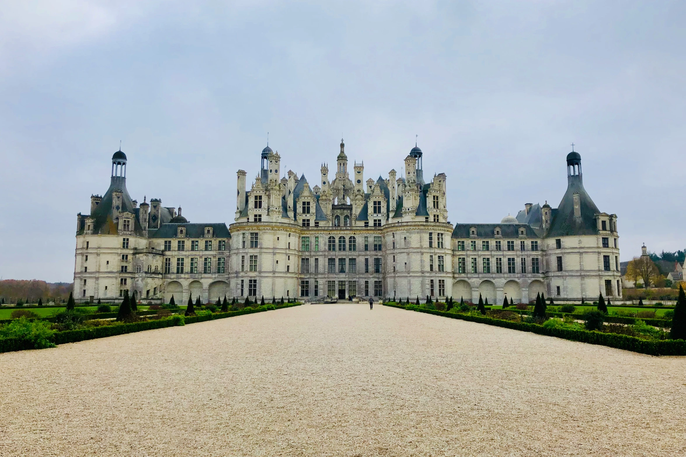 the long driveway has a big castle in the background