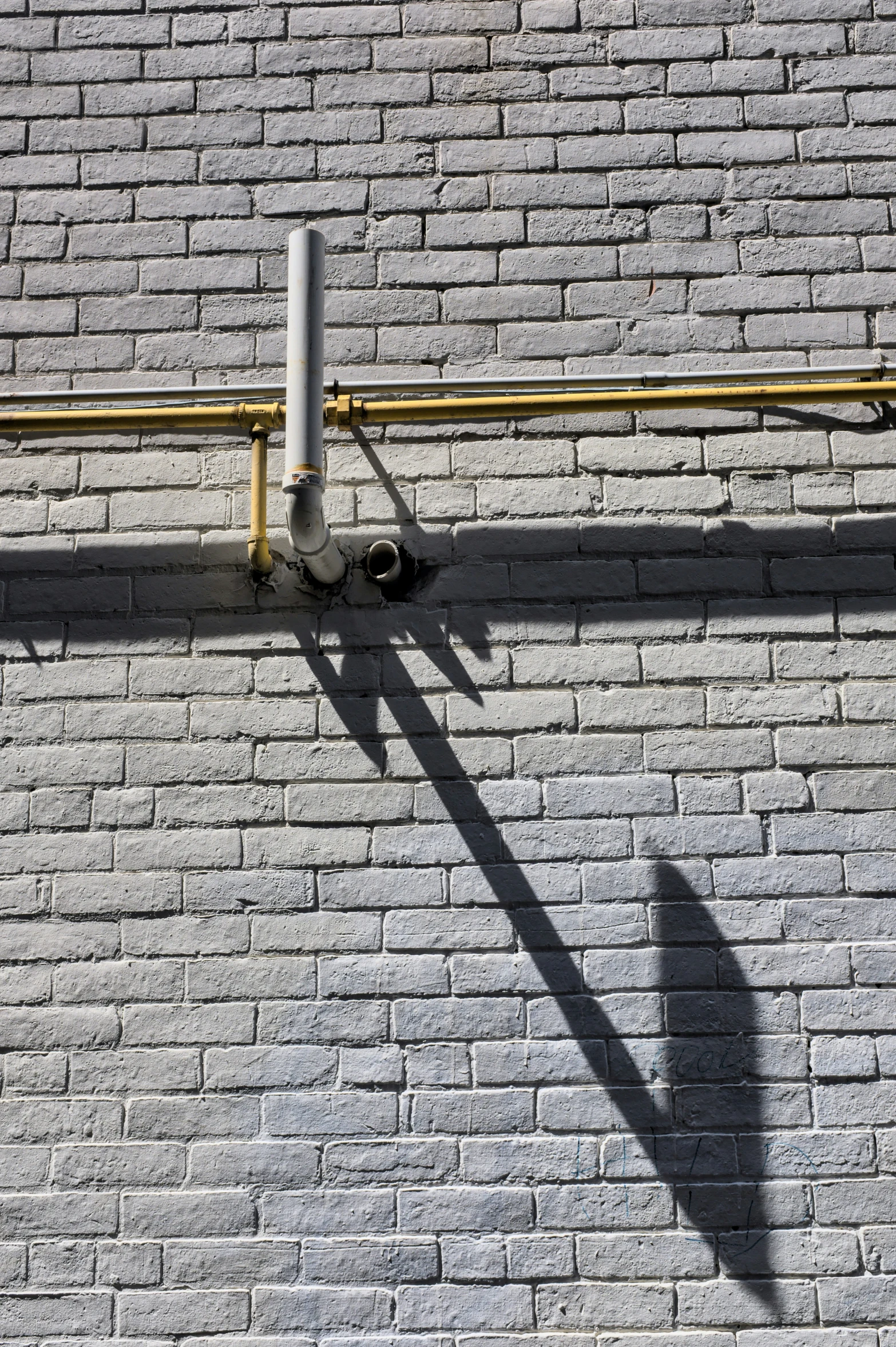 a man standing on a sidewalk with his shadow cast