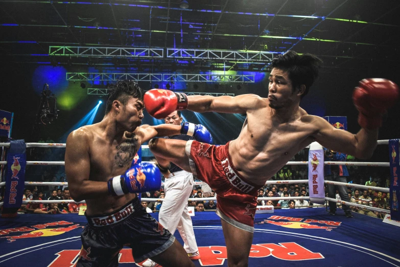 a male professional boxer and two others in boxing ring