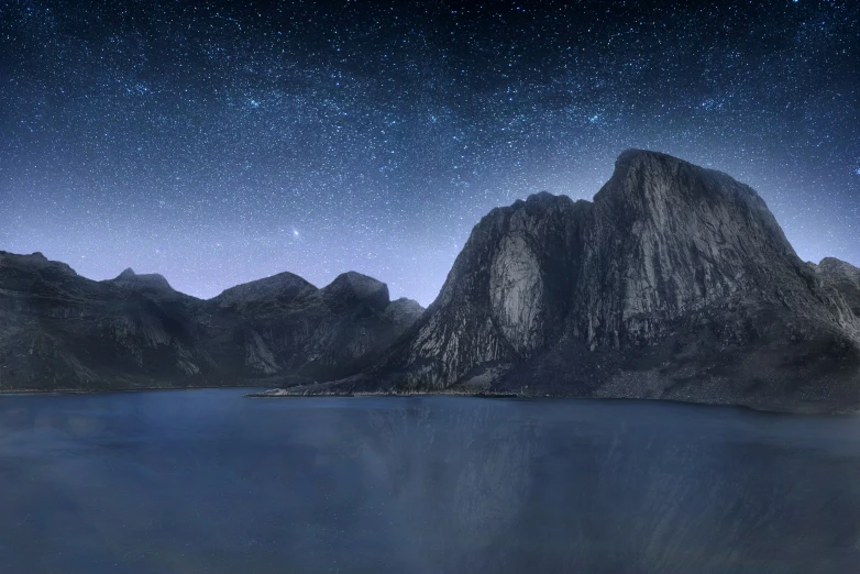 mountains and a lake with water underneath at night
