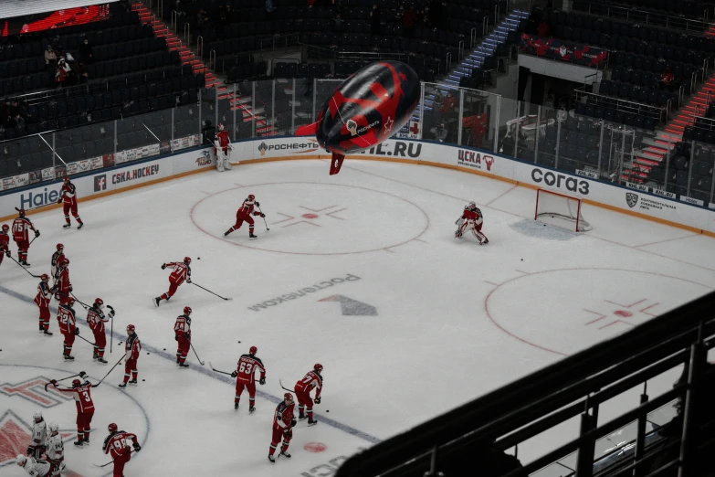 people playing on an ice rink surrounded by fans