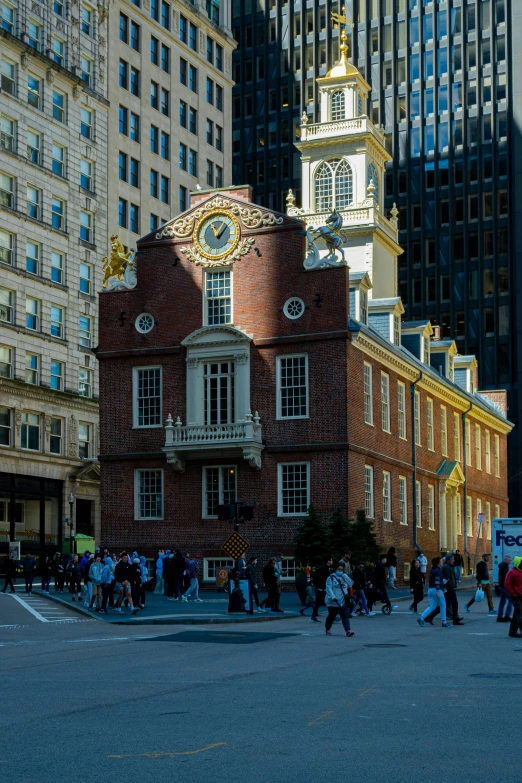 a brick building has a clock tower in the center