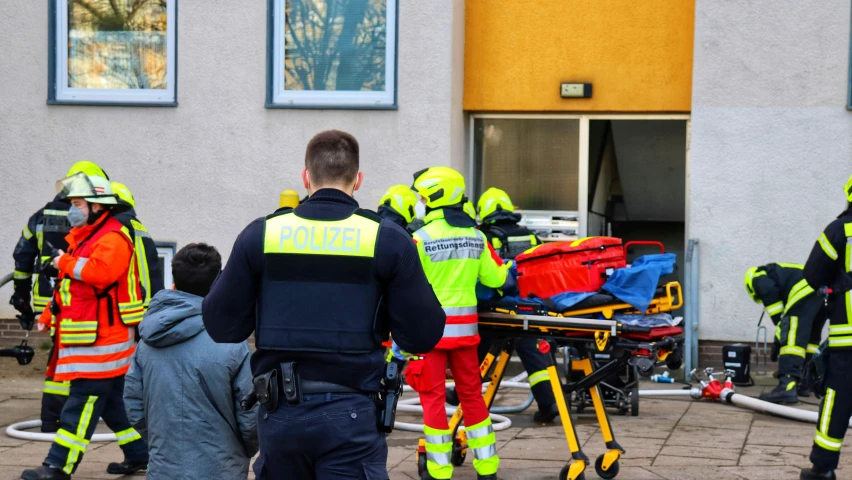 emergency responders outside an ambulance after being s and hit by police