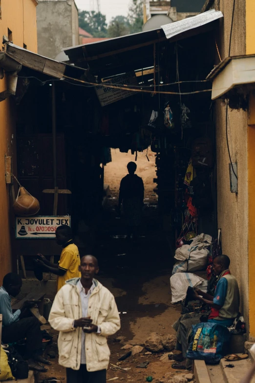 a man is walking down a street in front of a shack