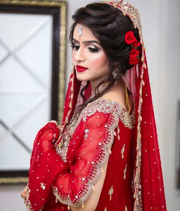 a woman in a red veil with a flower