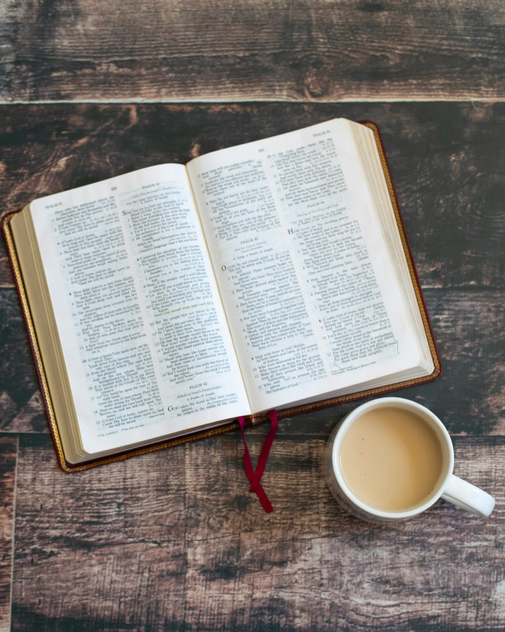 an open book next to a cup of coffee