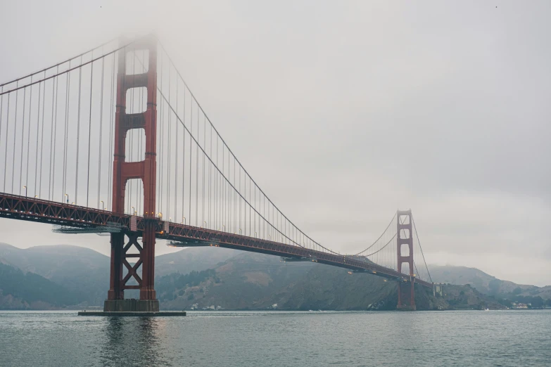 the golden gate bridge, as seen from the ocean on a misty day