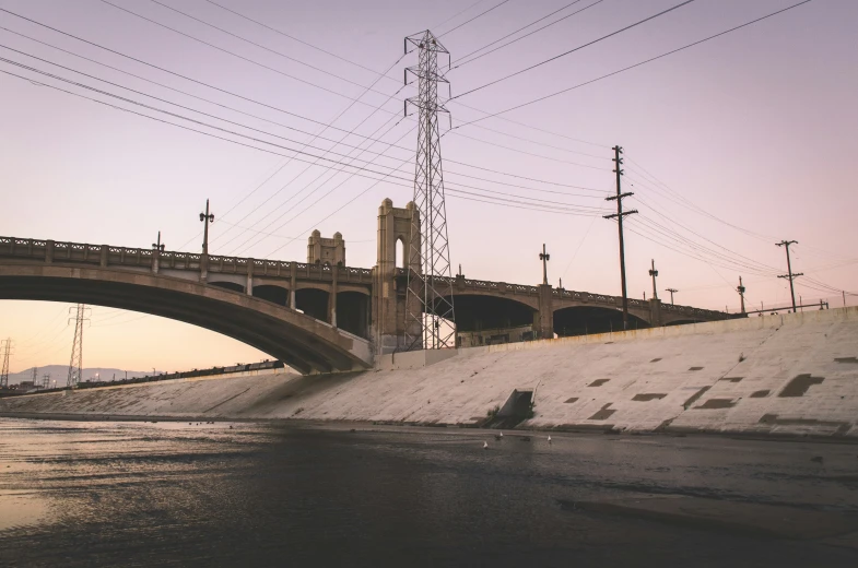 a bridge over a body of water under power lines