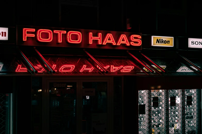 the lit up restaurant has bright neon signs on its side