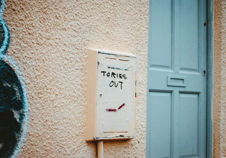 an old sign attached to the side of a building