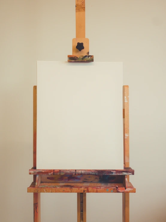 an easel and paper hang on a board