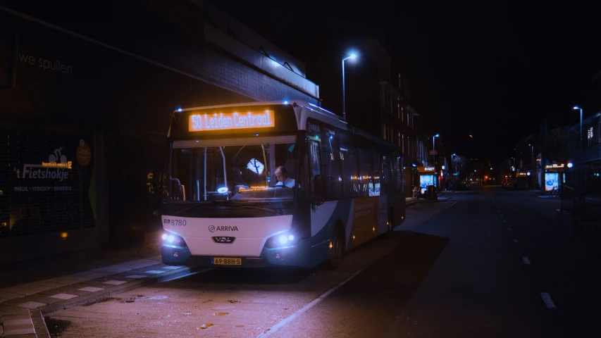 a bus on a street at night time