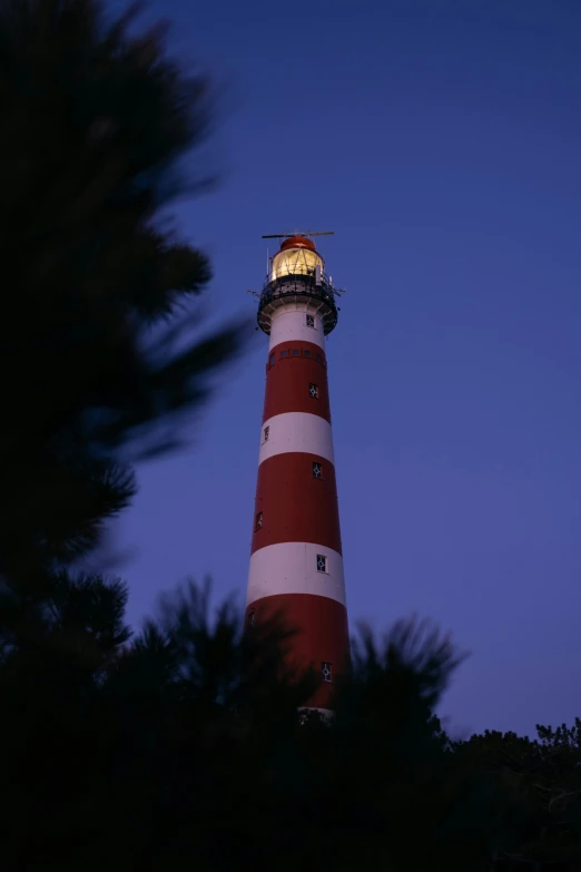 an upward view of a lighthouse with a clear sky