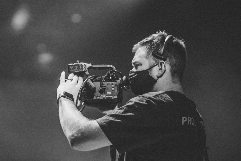 a man is pographing with a camera at night