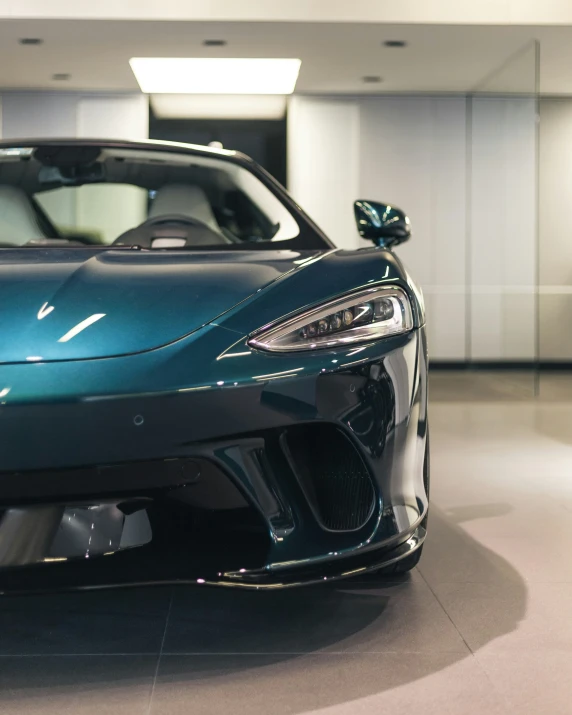 the front end of a blue, shiny sports car