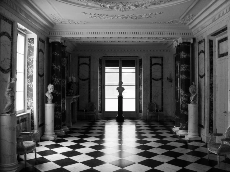 a very ornate room with windows and marble tiled floor