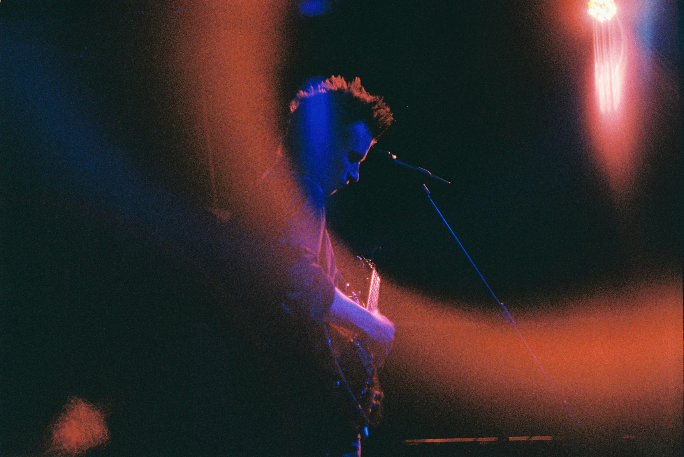 a man that is on stage with a guitar