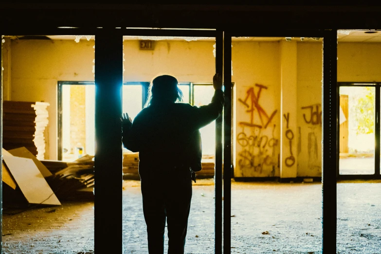 a person standing in front of a door with graffiti