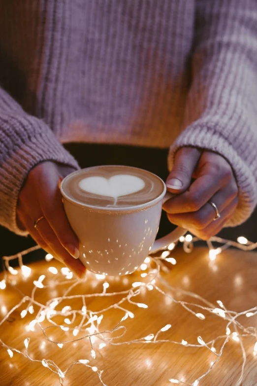 a coffee cup with some heart decorations in the foam