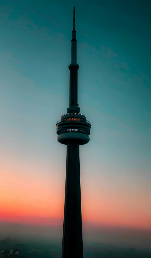 the top of a tall building with a clock on it