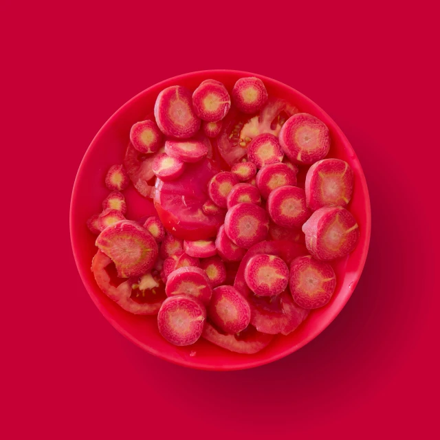 a bowl full of food that is red and yellow