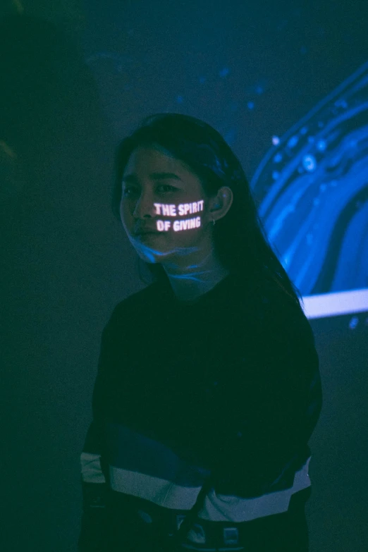 young man with neon light in his mouth standing