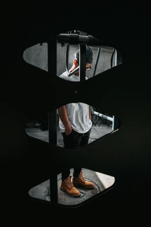 man in slippers taking picture in a circular mirror