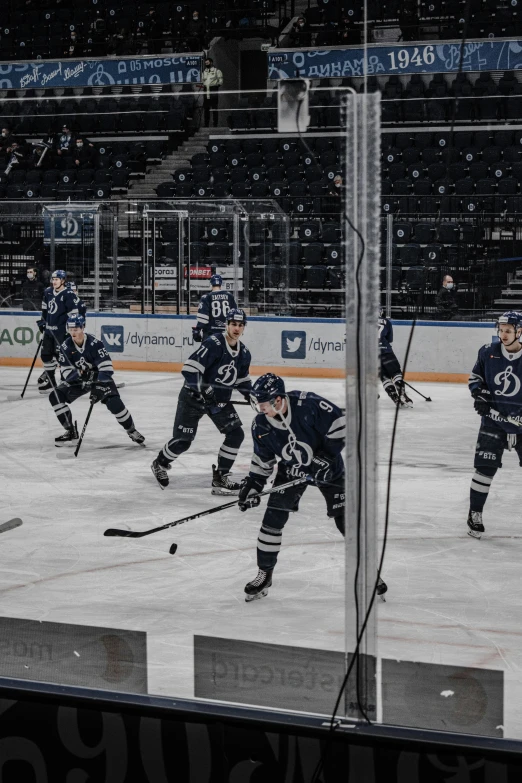 a group of men standing on top of a rink