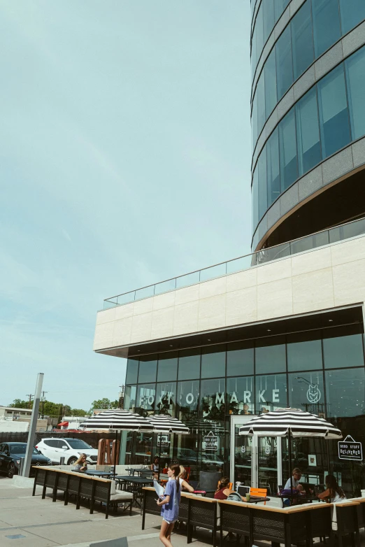 a building with many windows that have people sitting at tables