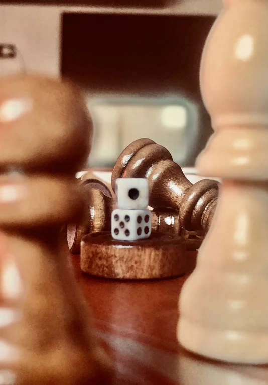 two pieces of wooden chess sit on a wood table