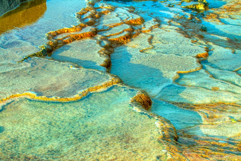 an aerial view of a river flowing next to the beach