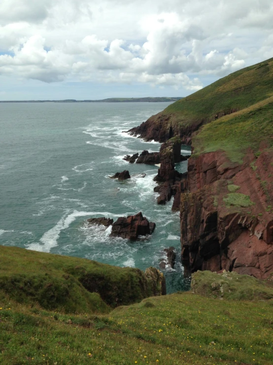 the ocean is crystal blue and green with rocks