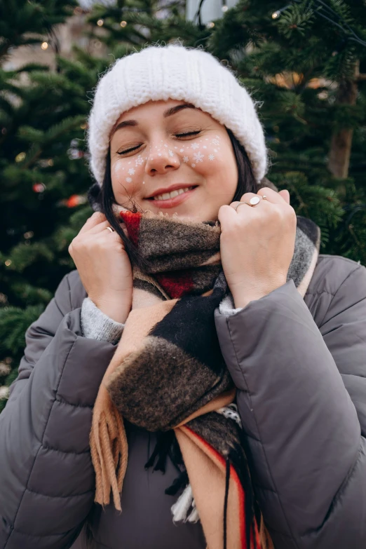 the woman is wearing a winter hat and scarf