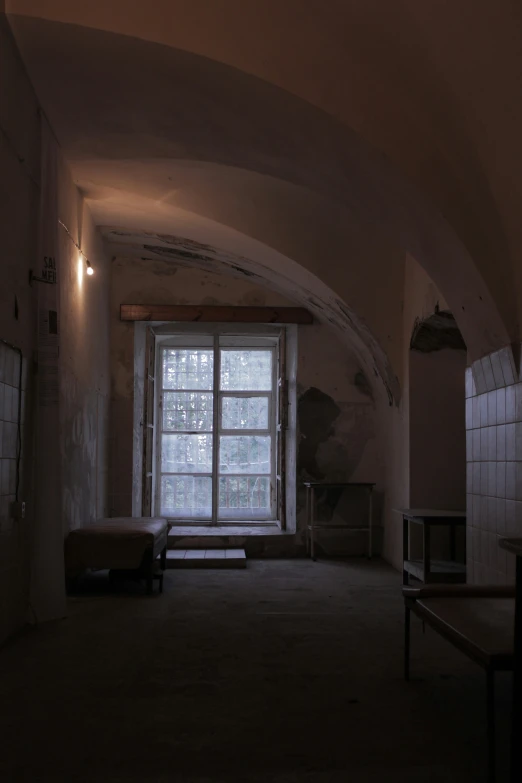 a room with large windows and stone walls