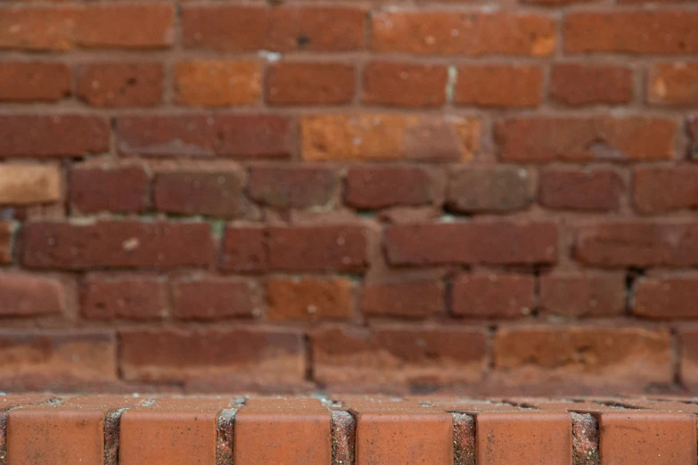 an old brick wall next to a green hydrant