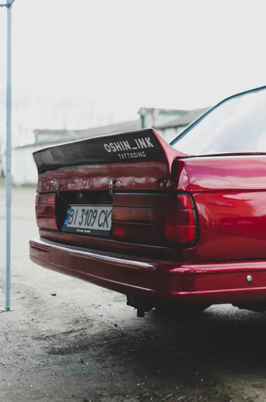 a close up of a parked red car near another car