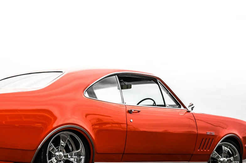 an old orange car is parked on the street