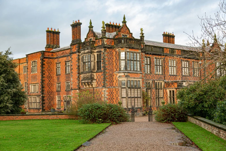 the large brick building has three chimneys