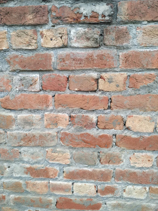 an old brick wall is shown with a red - brown and gray stain